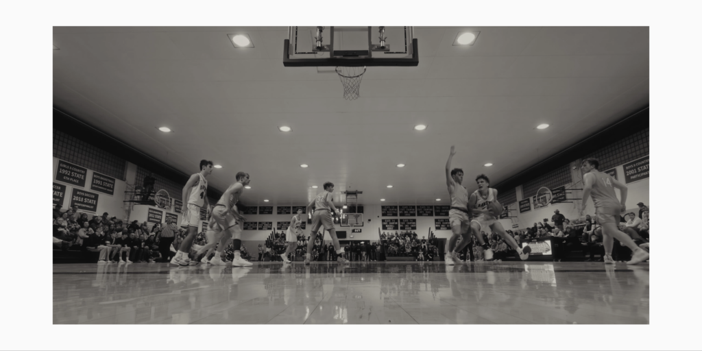 Close-up of a Hillcrest Academy basketball player focused during the game, emphasizing dynamic sports storytelling.